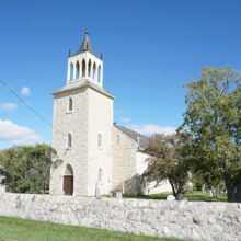 Image 1: St. Andrews Church behind a stone wall.