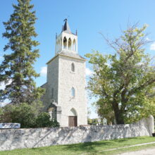 Image 2: St. Andrews Church behind a stone wall.