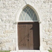 Image 5: St. Andrews Church wooden door with arched glass above entrance.