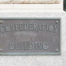 Image 5: Metal plaque on exterior wall, saying Confederation Building