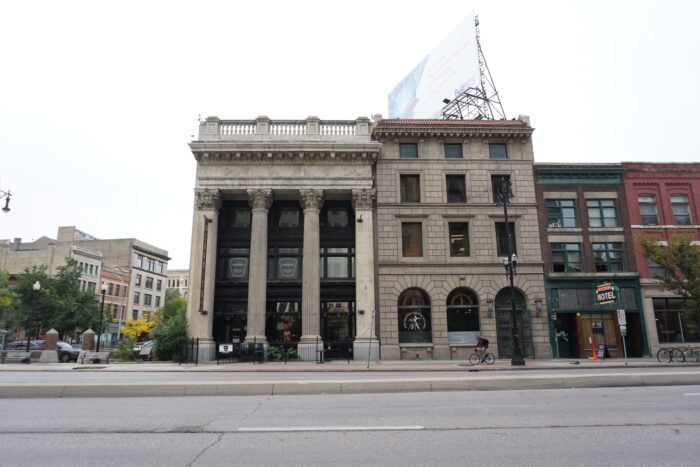 Winnipeg’s Bank of Toronto building viewed from across the street with three other buildings on the right.