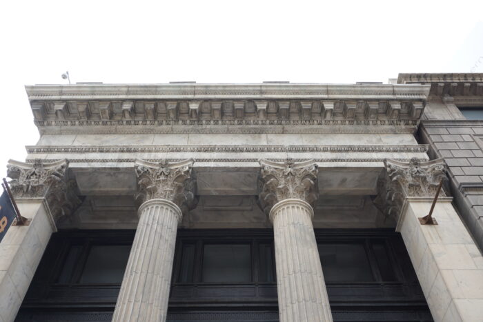 Looking up at the capital and cornice details of Winnipeg’s Bank of Toronto building.