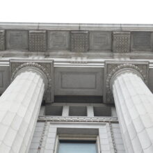 Image 4: Looking up at the facade of the Canadian Bank of Commerce with columns and architectural details