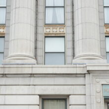 Image 8: Decorative architectural details on facade of the Canadian Bank of Commerce featuring windows