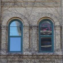 Image 10: Two arched windows on school facade