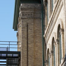 Image 12: Stone chimney on side of building