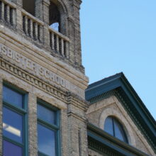 Image 13: The top half of the Isbister School front facade with “ISBISTER SCHOOL” carved into the stone.