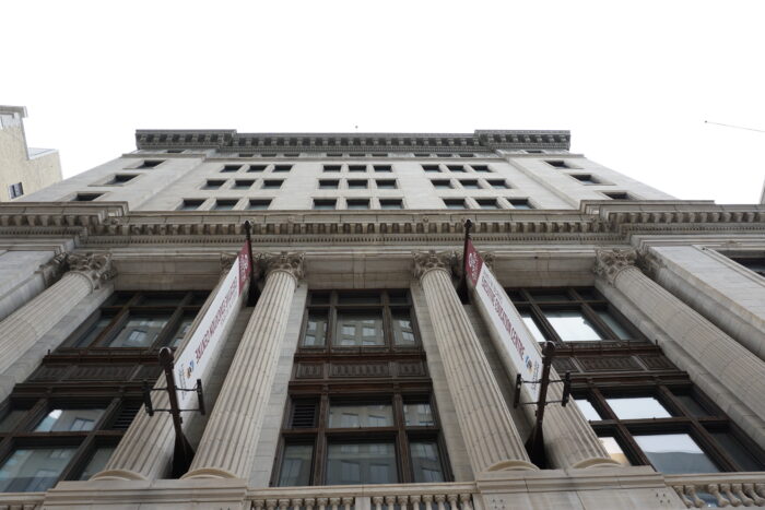 Looking up at the front facade of the Great West Life building.