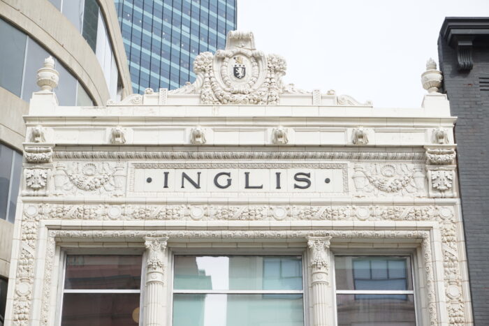 The ornamentation at the top of the front facade of the Inglis Building with “INGLIS” in the middle.