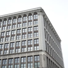 Image 1: Looking up the corner facade of the Paris Building