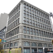 Image 3: Looking up the corner facade of the Paris Building from street level at the corner of Hargrave Street and Portage Avenue