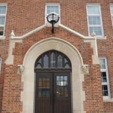 Image 5: A set of entrance doors to MacKenzie School with a light fixture above.