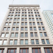 Image 1: Looking up at the facade of the Railway Chambers Building from street level