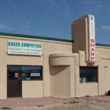 Image 3: Greenings Garage building with a sign reading “Baker Computers” on the front.