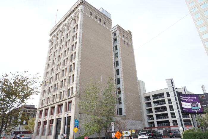 The back of the Railway Chambers Building with a parkade next door.