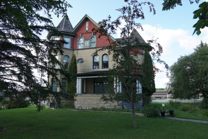 Myers House with trees in the foreground obscuring part of the facade.