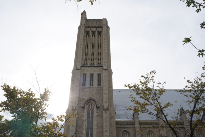 The tower of Knox Church with trees growing up below it.