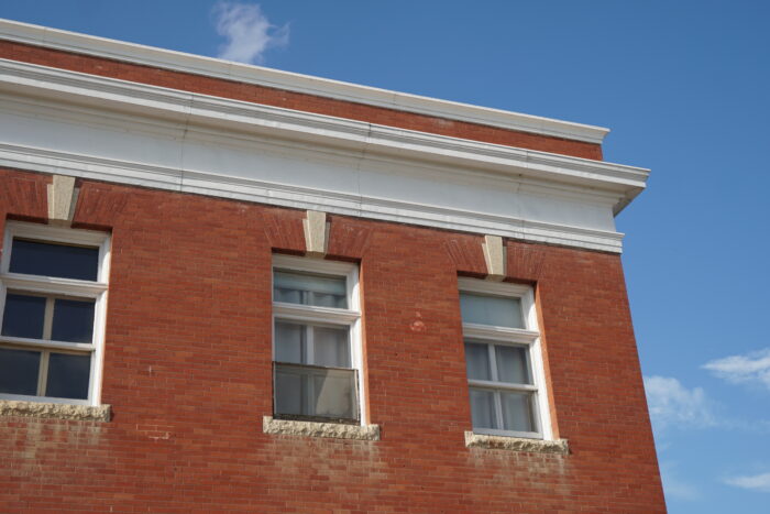 Three windows on the top floor of the Neepawa Post Office.