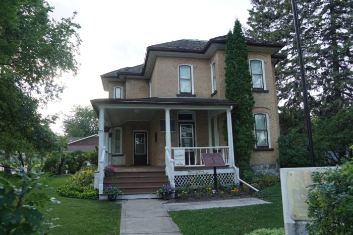 Margaret Laurence House with a sign reading “CLOSED” posted on the verandah.