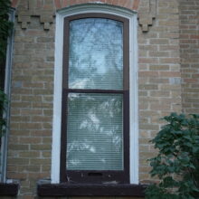 Image 2: Slightly arched window on front of house