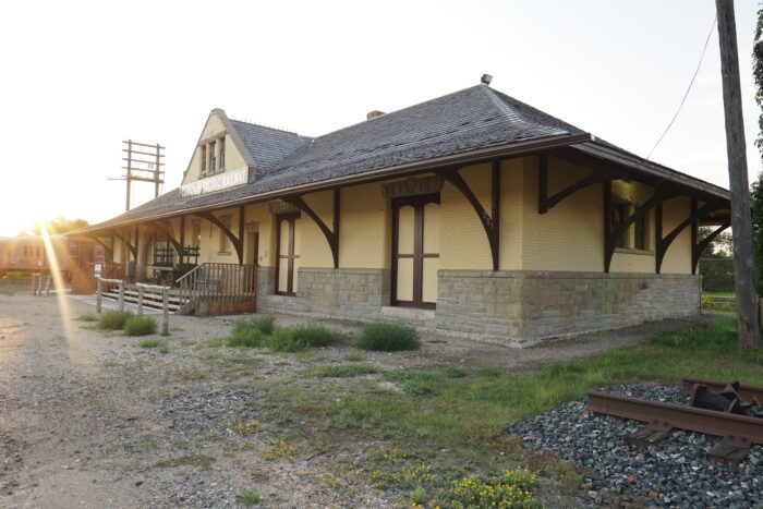 Portage La Prairie’s Canadian Pacific Railway Station with a railway car in the background.