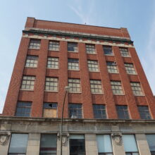 Image 1: Looking up at the front facade of the McKenzie Building