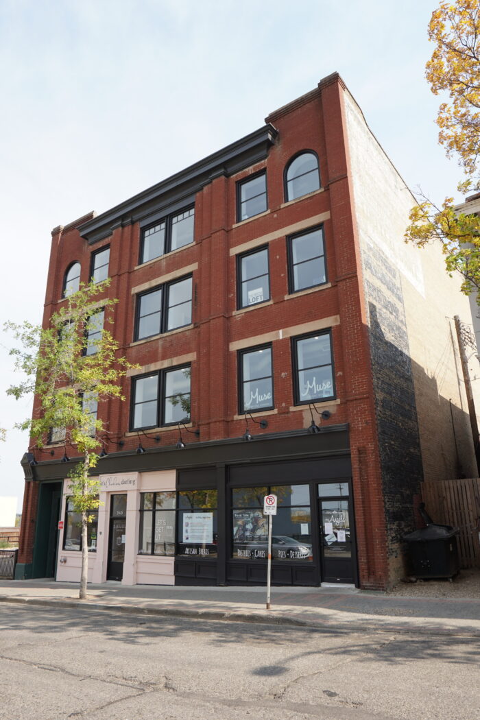 The Campbell & Campbell Building with a tree and no parking sign in front.