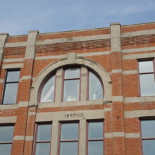 Image 1: Arched windows on 2nd floor