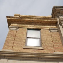 Image 1: Looking up at upper corner window of Brandon’s Canadian Pacific Railway Station building