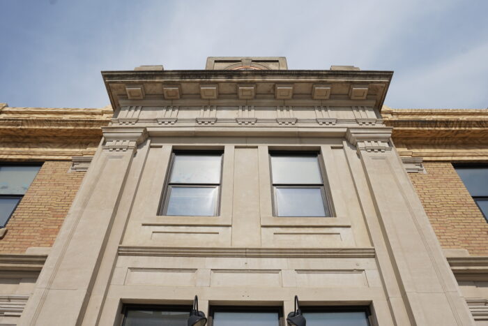 Looking up at two windows above the front entrance of Brandon’s Canadian Pacific Railway Station building.