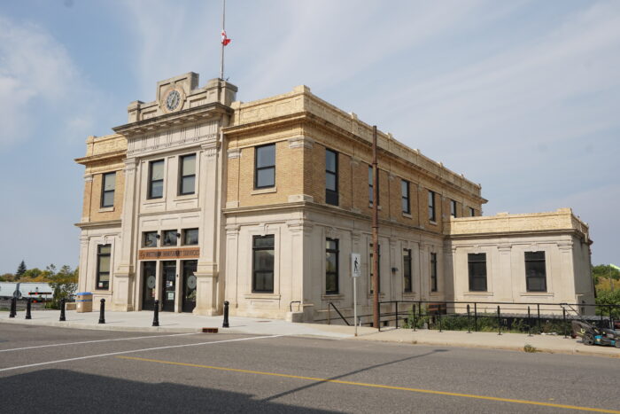 Brandon’s Canadian Pacific Railway Station building. A Canadian flag flies at half mast on the roof.