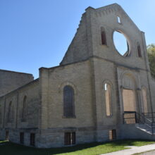 Image 1: The front facade of the Trappist Monastery Church. The windows have no glass.