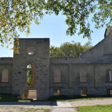 Image 14: Side wall with entrance and row of arched windows.