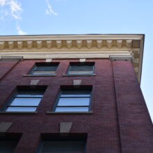 Image 2: Looking up at third and fourth floor windows and underside of roof cornice