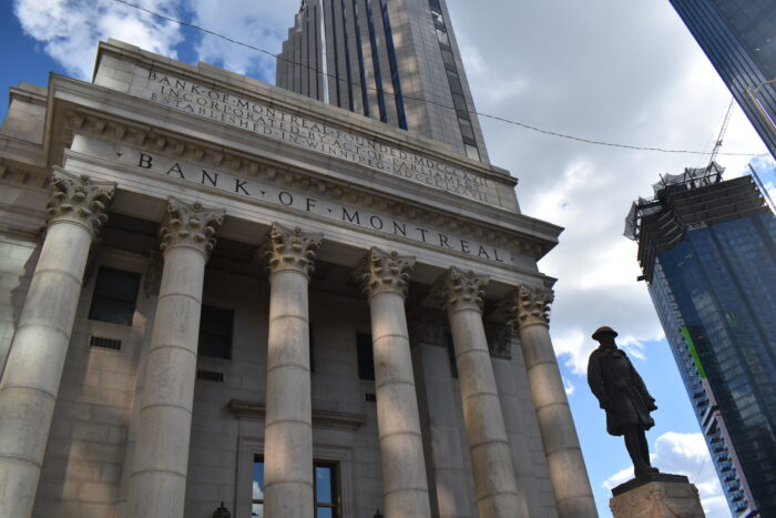 The front facade of Winnipeg’s downtown Bank of Montreal building. A sculpture of a soldier stands in front.