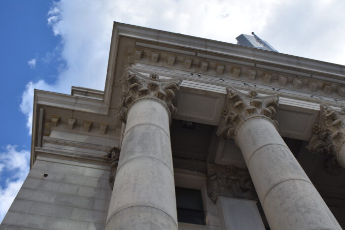 Image 1: Looking up at the capital and cornice details of Winnipeg’s downtown Bank of Montreal building.