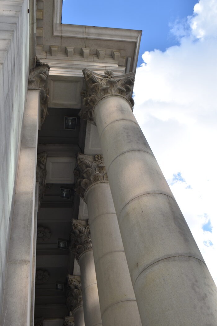 Image 2: Looking up at the capital and cornice details of Winnipeg’s downtown Bank of Montreal building.