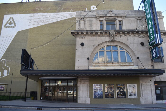 The front entrance of the Walker Theatre. A sign reading “CUMMMINGS THEATRE” projects from the facade.