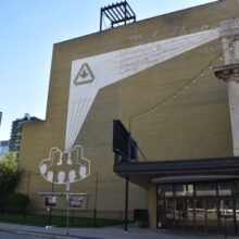 Image 4: Facade the building just left of the original theatre's facade featuring a mural