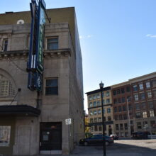 Image 5: Facade of the Walker Theatre with buildings behind it on Donald Street in view on the right