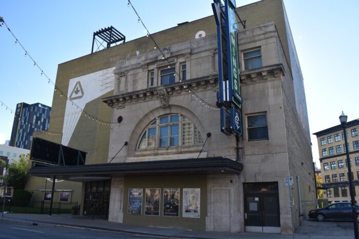 The front entrance of the Walker Theatre with three strings of lights extending out from the facade.