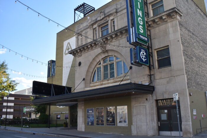 The front entrance of the Walker Theatre with three strings of lights extending out from the facade.