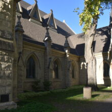 Image 2: Holy Trinity Church with a cedar tree growing up along the facade.