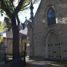 Image 7: Holy Trinity Church with a cedar tree growing up along the facade.