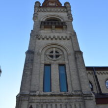 Image 2: Looking up the facade of the tower of St May's Cathedral featuring decorative religious architectural details