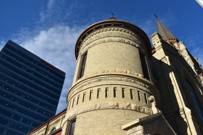 A tower on the front of St. Mary’s Cathedral. A building with a “Scotiabank” sign is behind.