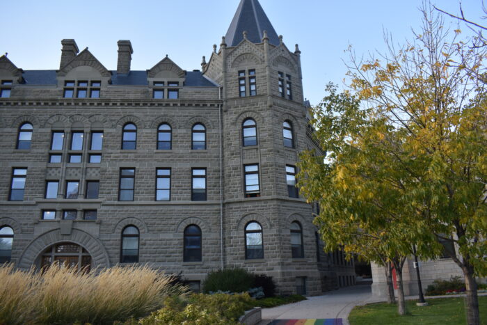 Wesley Hall at the University of Winnipeg with landscaping growing in front.