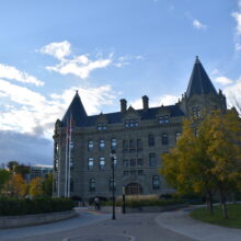 Image 3: Front facade of Wesley Hall from a distance with both turrets visible