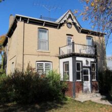 Image 1: Fowler House facade with small porch and balcony above