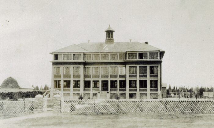 The Rossville Indian Mission building in Norway House, behind a fence.